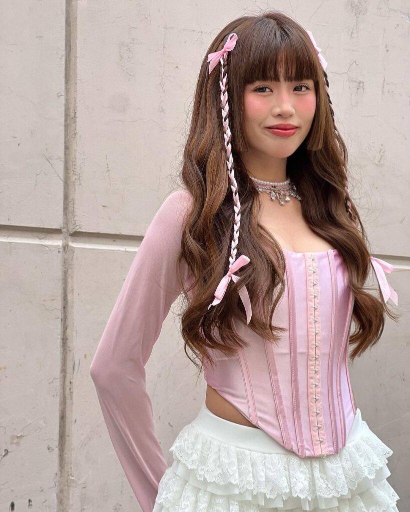 Maloi wearing pink corset top