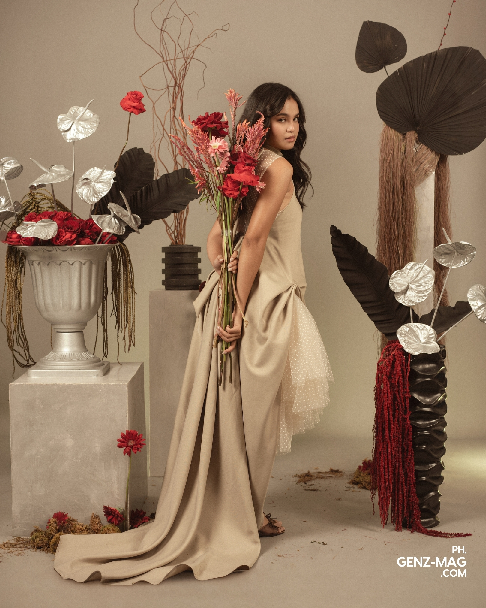 Zephanie in a draped beige gown with a long train, holding a bouquet of red roses and pink blooms behind her back, floral styling by Makati Flower Atelier, shot at The Villa Studios, for GEN Z Magazine's cover story with Michael Sager